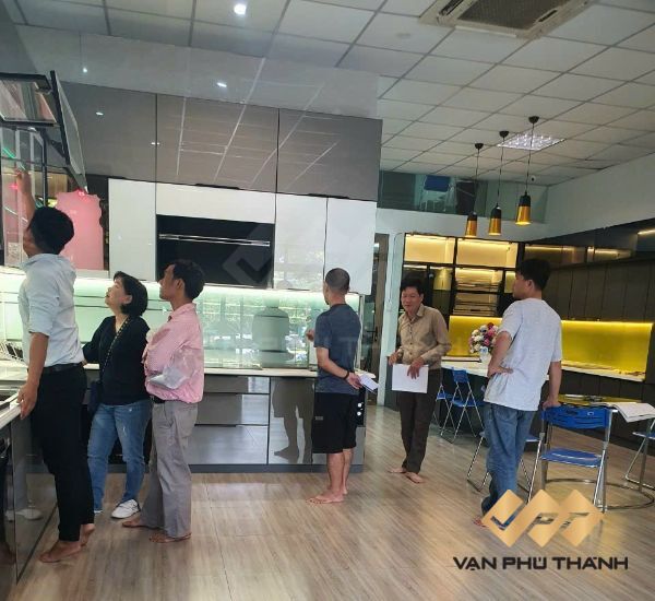 Khách hàng tham quan tìm hiểu các mẫu tủ bếp nhôm kính treo tường đẹp tại showroom Bếp Vạn Phú Thành